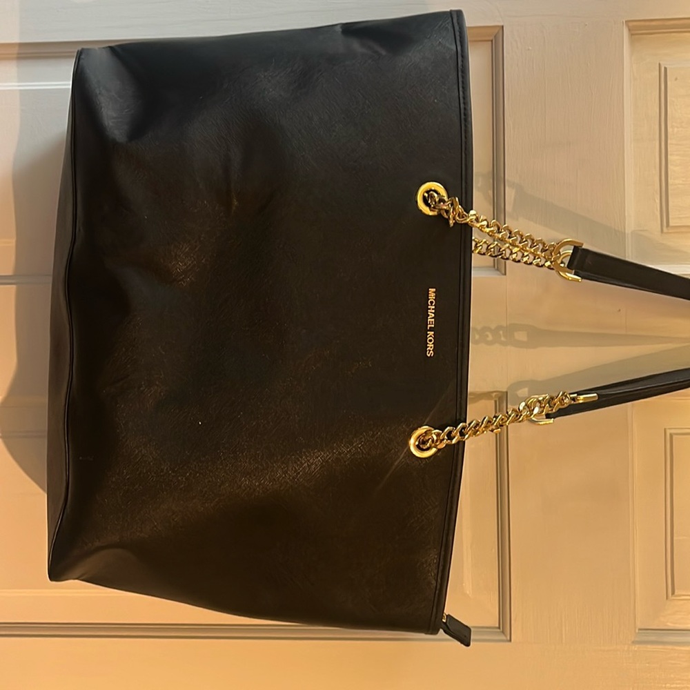 Black Micheal Kors tote bag, has laptop sleeve. Gold accents